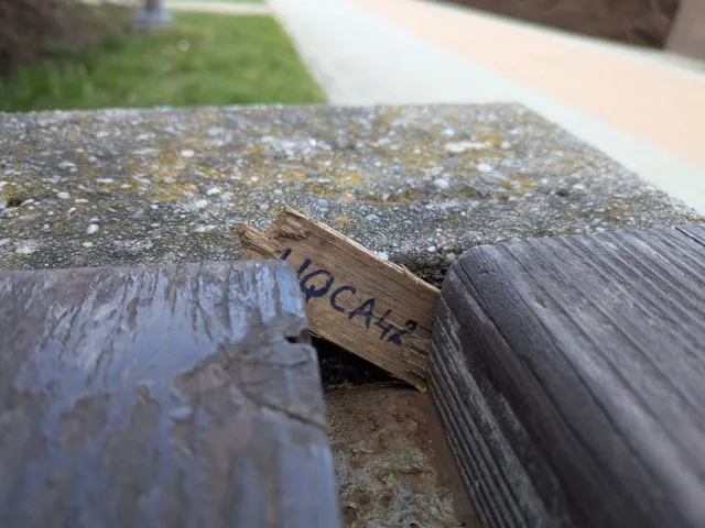 Code on a piece of wood.
